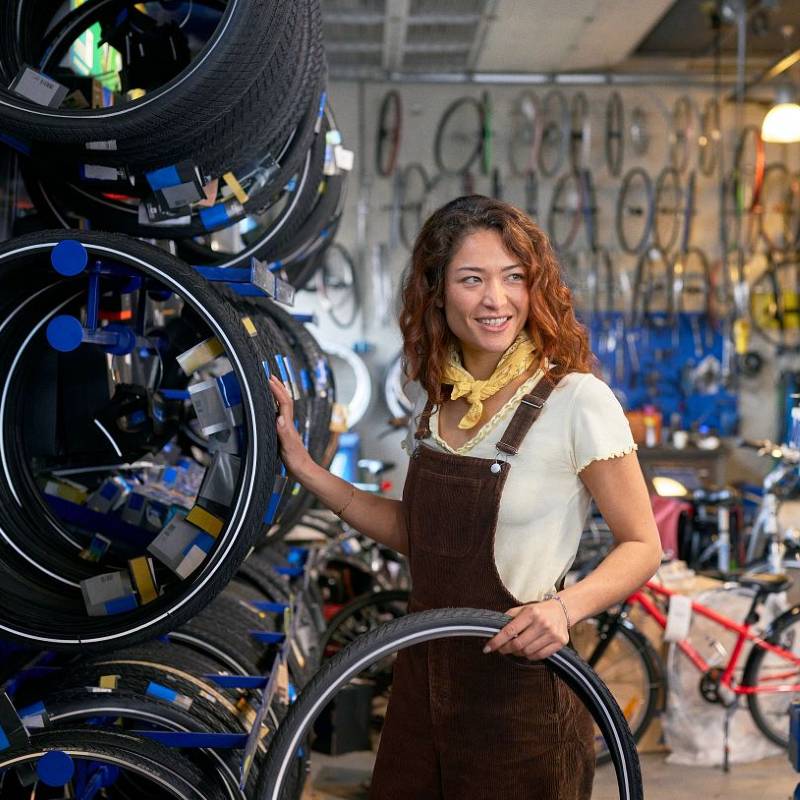 Young woman working in bicycle shop