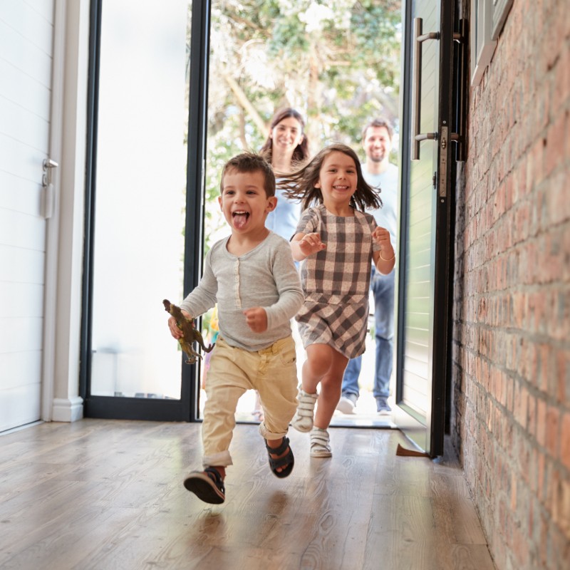 children running in door of house