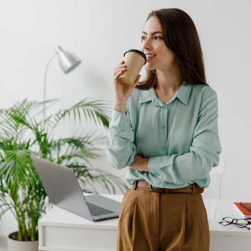 woman in office drinking coffee