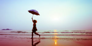 silhouette of happy running woman with umbrella 