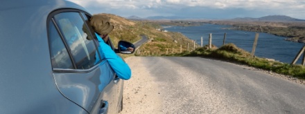 man looking out car window