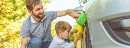 father and son washing car
