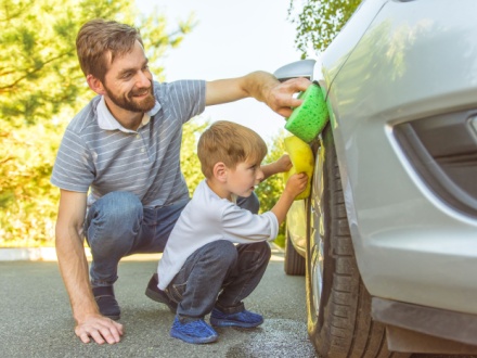 father and son washing car