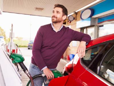 man filling car with petrol