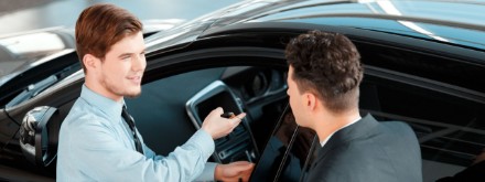 two men selling a car