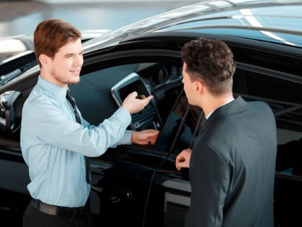 two men selling a car