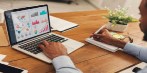entrepreneur analyzing graph on laptop