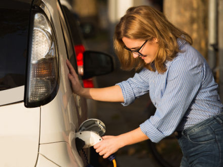 woman recharging car