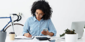 woman calculating on phone