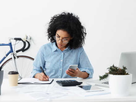 woman calculating on phone