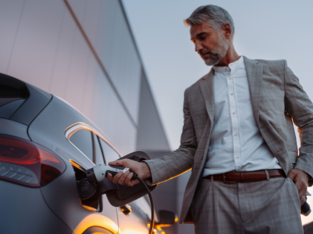 man charging ev car