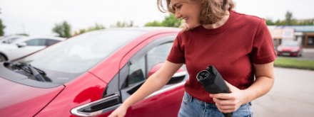 woman charging ev car