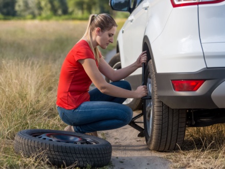 woman changing tyre