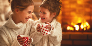 mother and daughter at home by fire