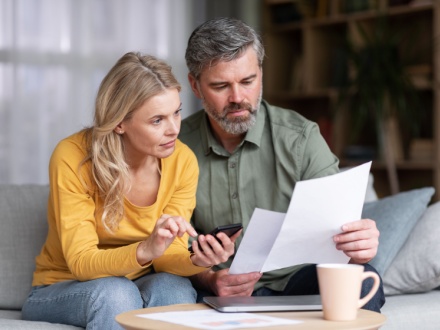 couple at home doing paperwork