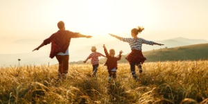 happy family running in a field