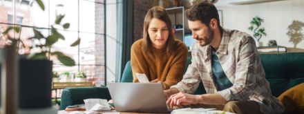 young couple at home doing paperwork