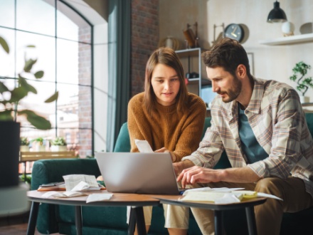 young couple at home doing paperwork