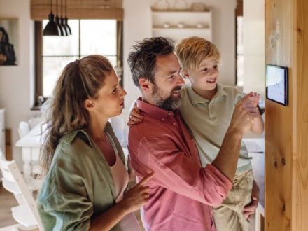 couple at home setting thermostat
