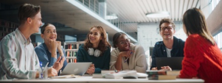 college students sitting around a table chatting