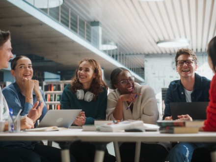 college students sitting around a table chatting