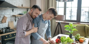 Gay couple cooking dinner