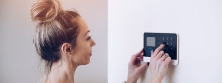 woman setting home alarm