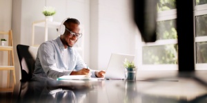 man at desk with headphones on
