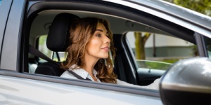 woman driving silver car