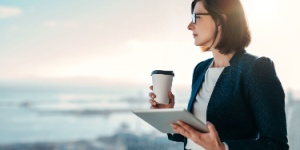 woman with coffee and tablet