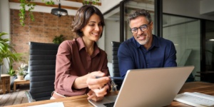 male and female office workers at laptop
