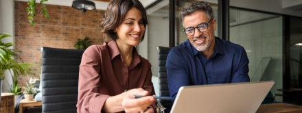 male and female office workers at laptop
