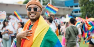 smiling man celebrating pride parade