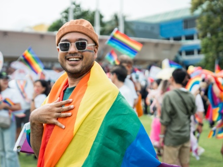 smiling man celebrating pride parade