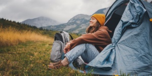 woman camping in blue tent