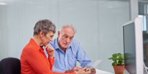 male and female office workers at a desk
