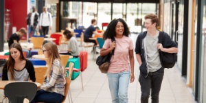 two college students walking in communal college area