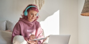 hipster teenager in bedroom studying