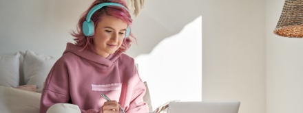 hipster teenager in bedroom studying