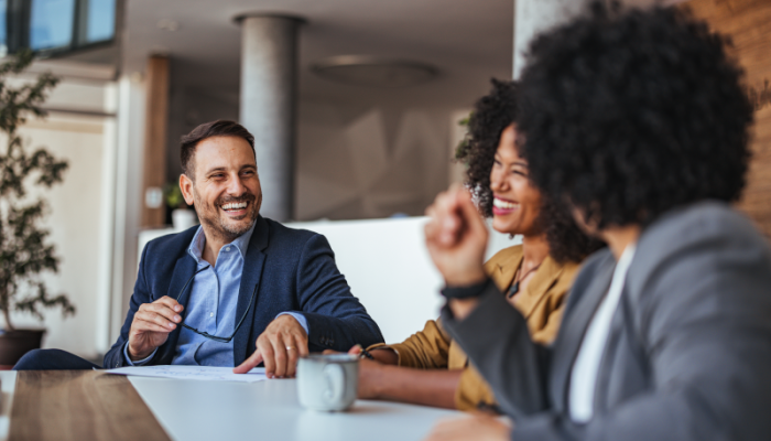 three office workers laughing