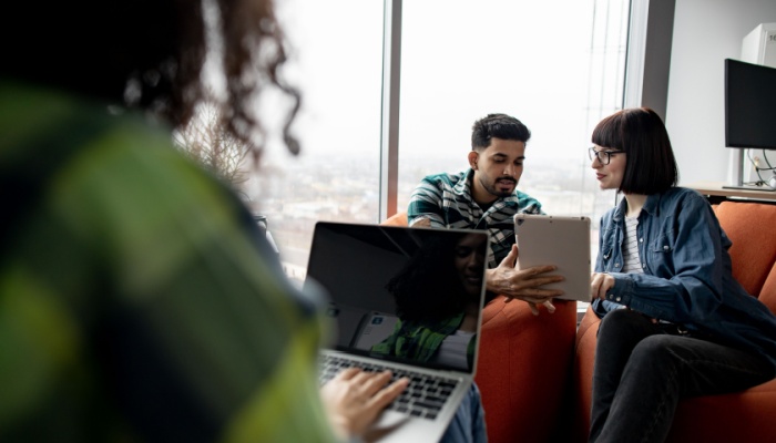 group of people in office on laptops