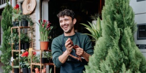 Smiling man outside a florist