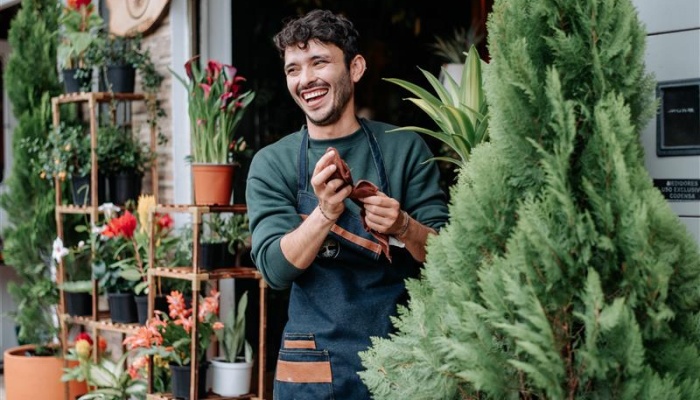 Smiling man outside a florist