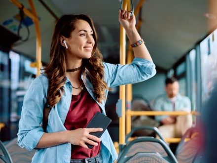 woman on public transport listening to music