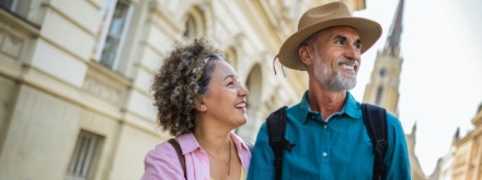 Middle aged couple on city break reading a map