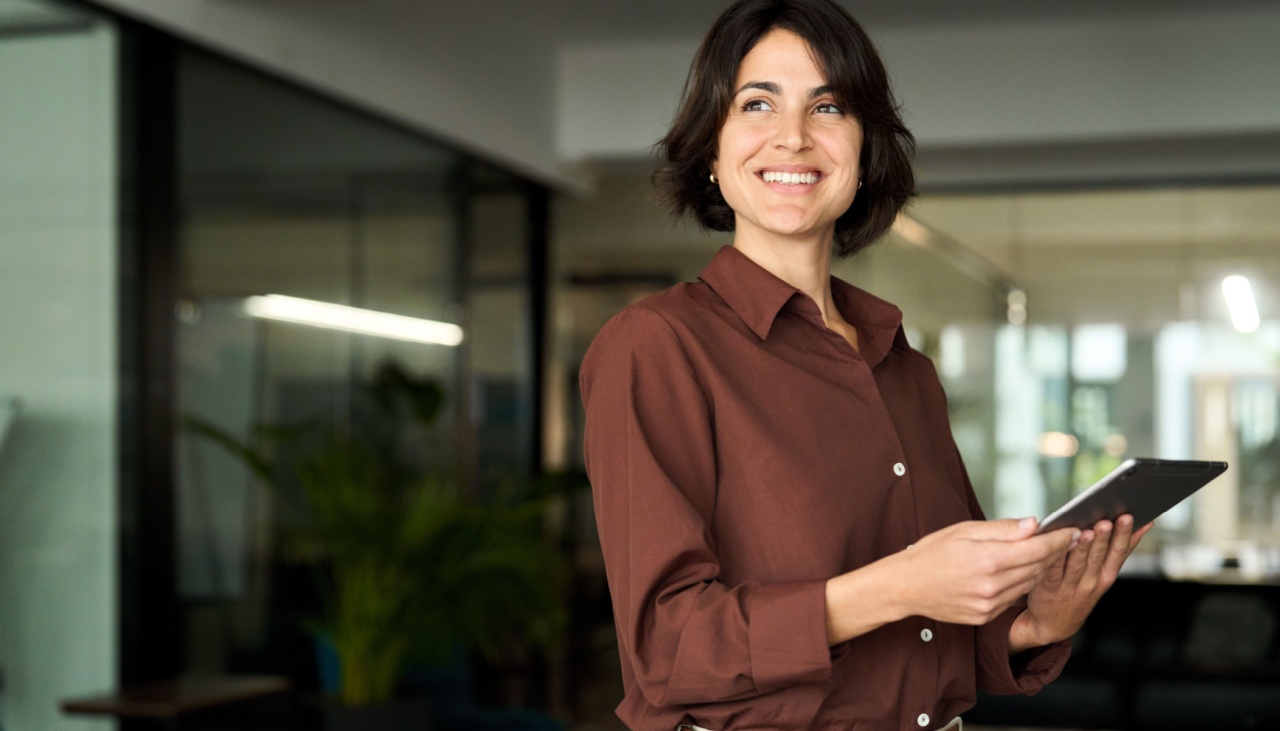 Hispanic woman in office on tablet