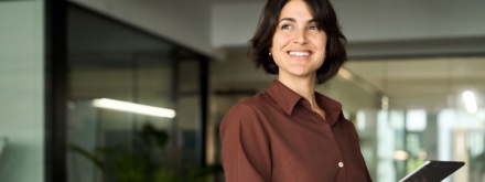 Hispanic woman in office on tablet