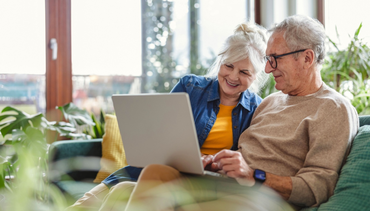 senior couple at home on laptop