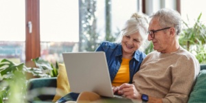 senior couple at home on laptop