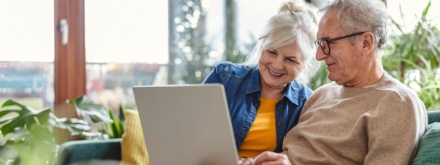 senior couple at home on laptop